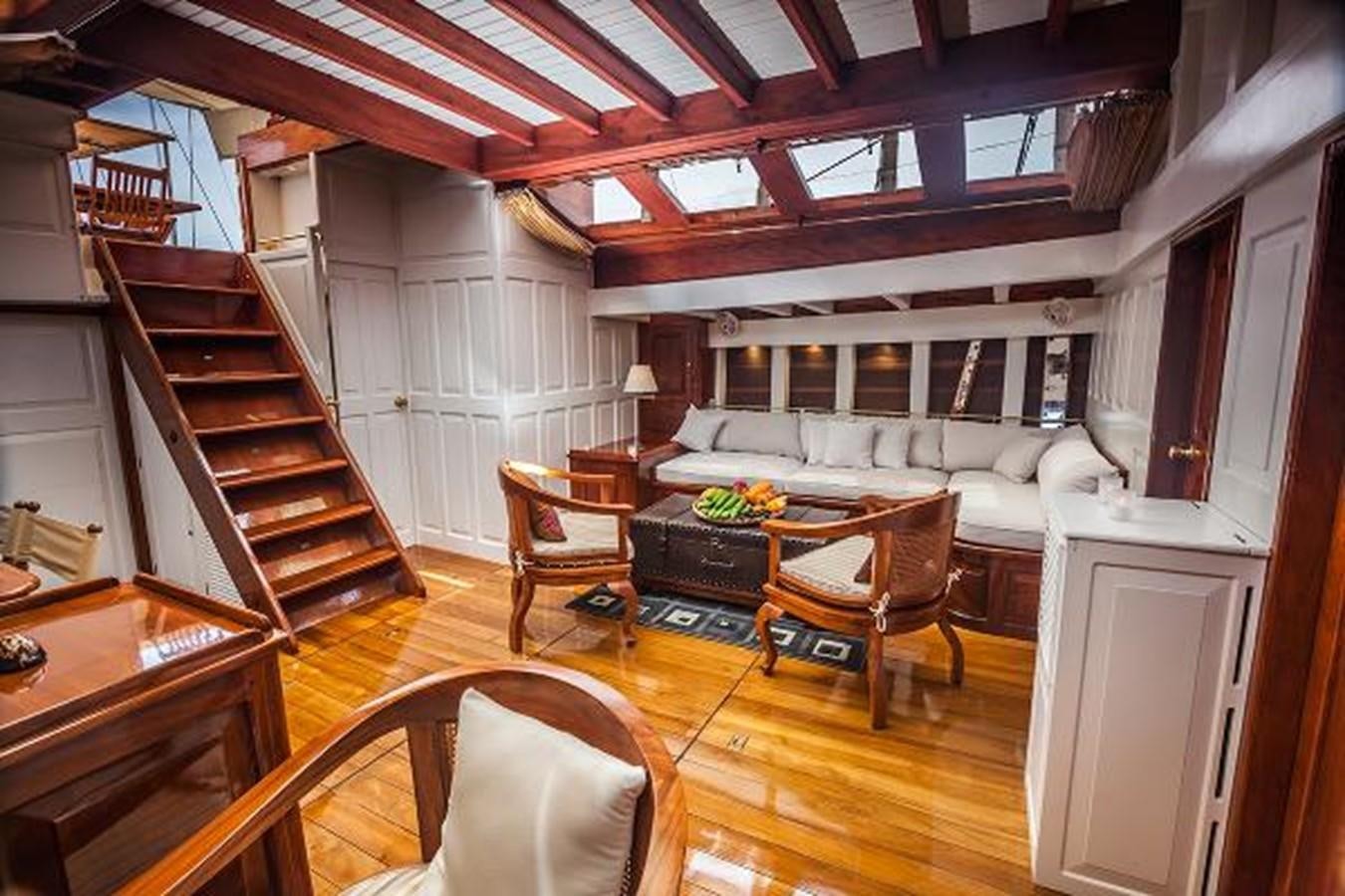 a living room with a staircase and furniture aboard 95FT 2011 CUSTOM KETCH CLASSIC YACHT Yacht for Sale