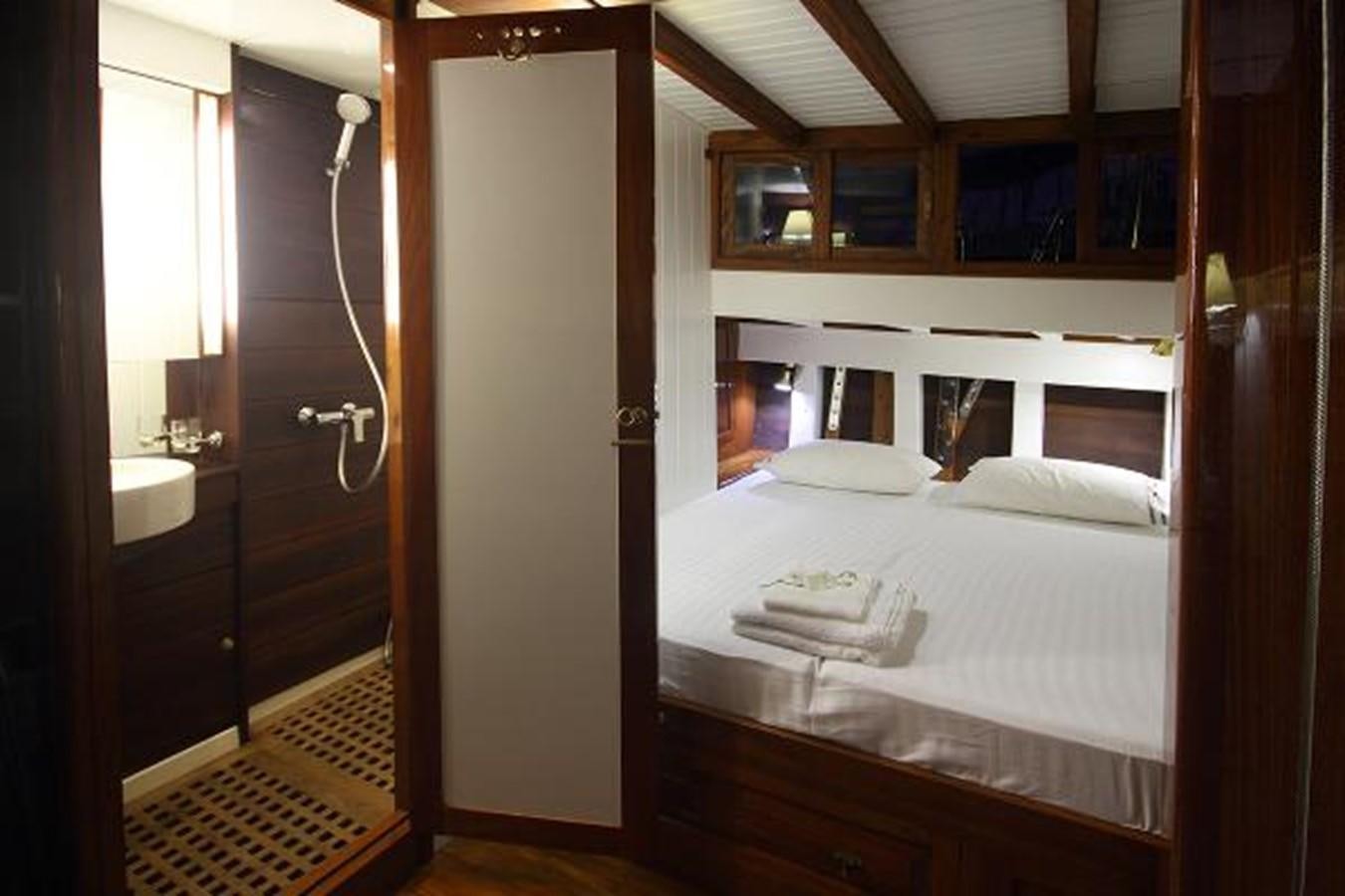 a bed in a room aboard 95FT 2011 CUSTOM KETCH CLASSIC YACHT Yacht for Sale