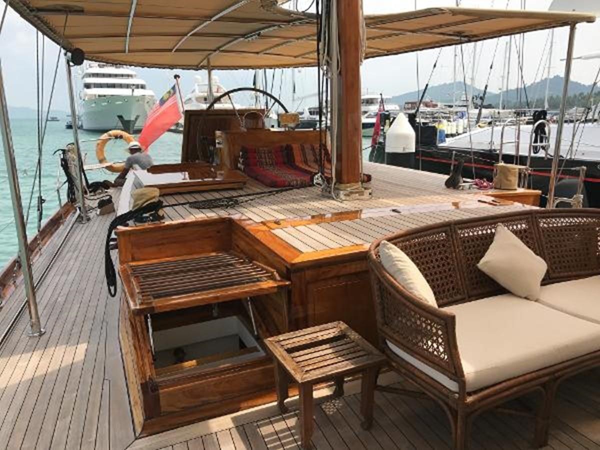 a boat with a bench and chairs aboard 95FT 2011 CUSTOM KETCH CLASSIC YACHT Yacht for Sale