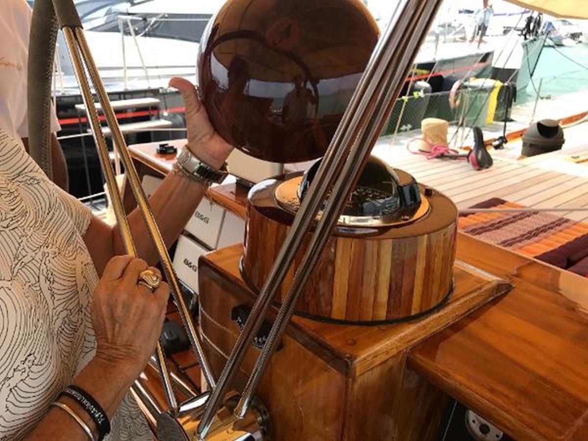 a person holding a metal object aboard 95FT 2011 CUSTOM KETCH CLASSIC YACHT Yacht for Sale