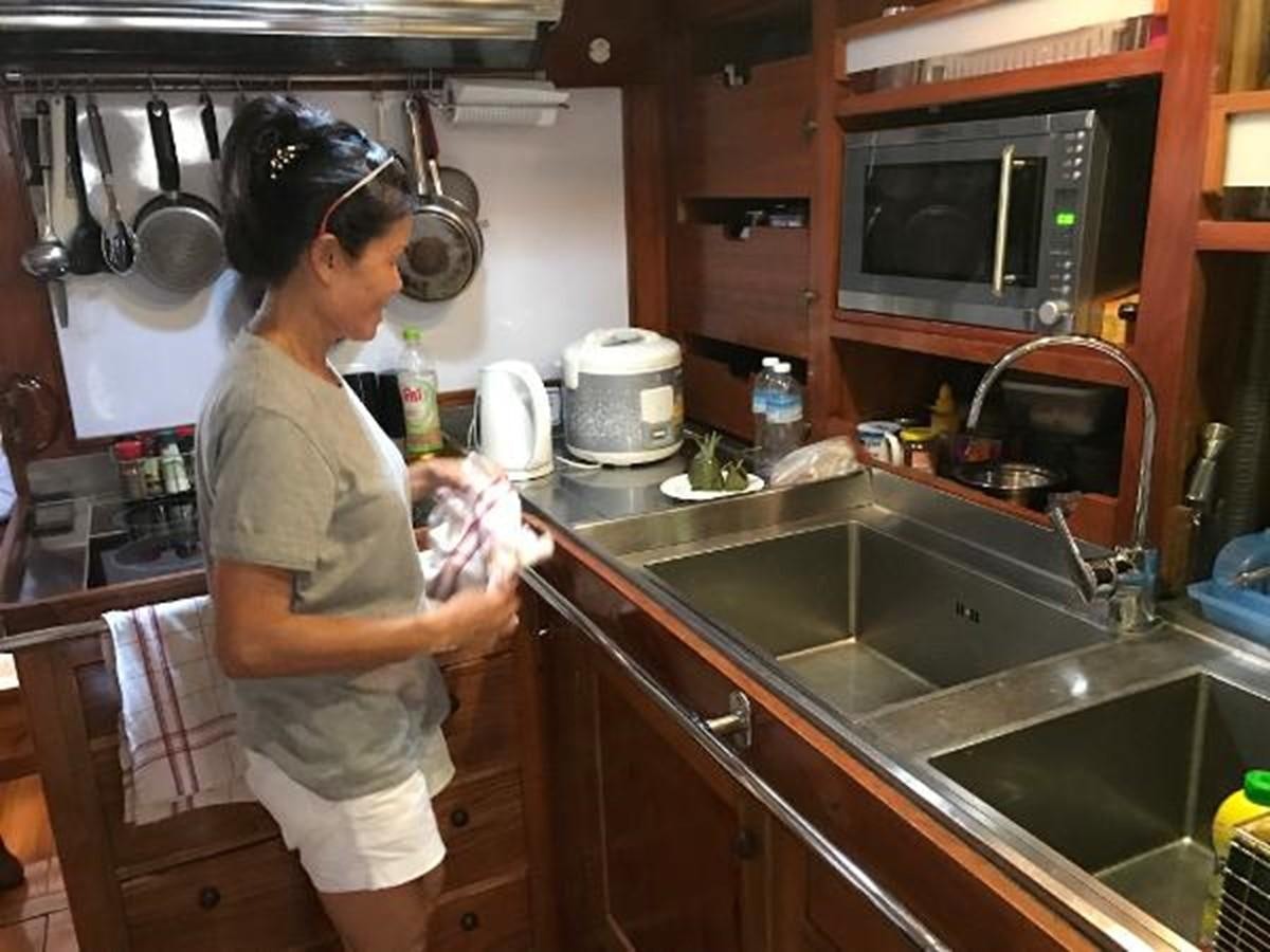 a person in a kitchen aboard 95FT 2011 CUSTOM KETCH CLASSIC YACHT Yacht for Sale