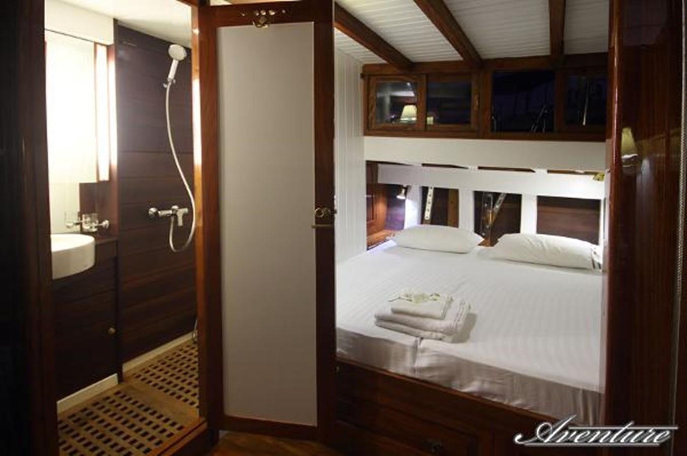 a bedroom with a double bed aboard 95FT 2011 CUSTOM KETCH CLASSIC YACHT Yacht for Sale