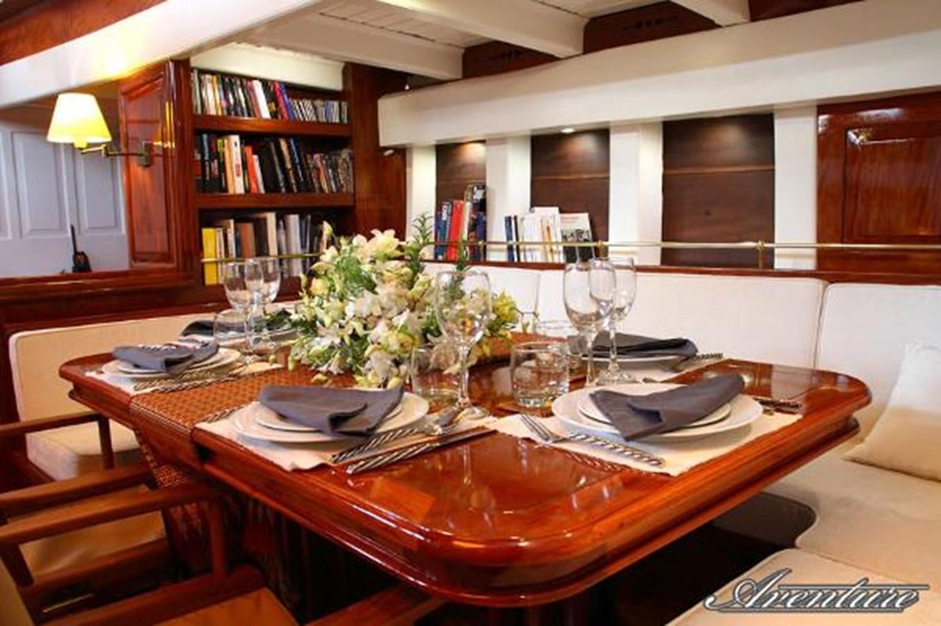 a table with plates and glasses on it aboard 95FT 2011 CUSTOM KETCH CLASSIC YACHT Yacht for Sale