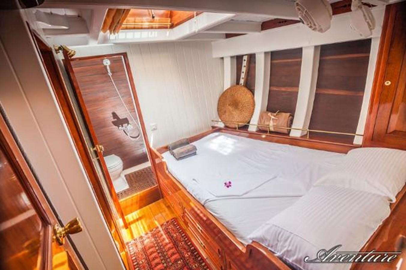 a room with a bed and a door aboard 95FT 2011 CUSTOM KETCH CLASSIC YACHT Yacht for Sale