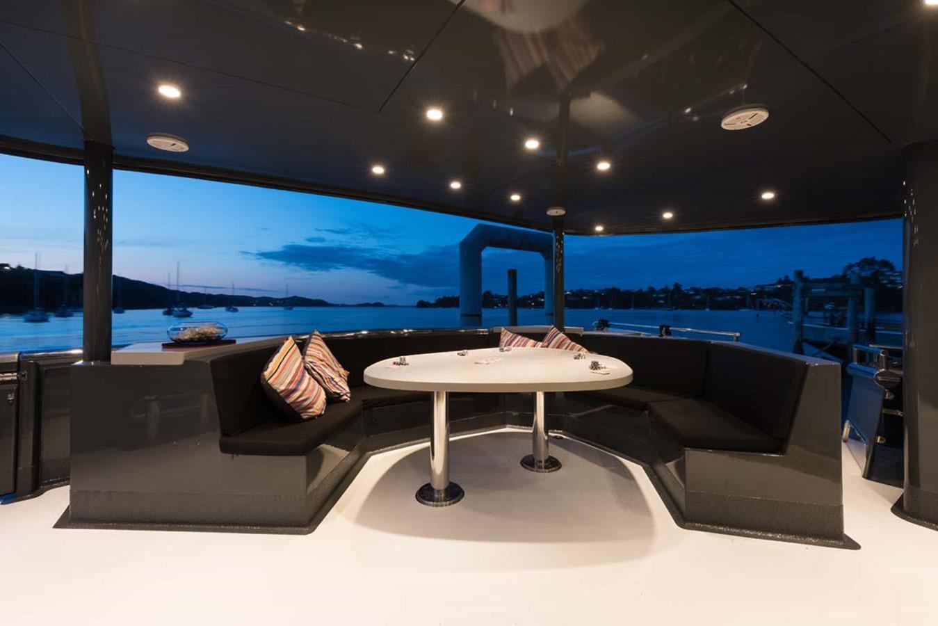 a room with a table and a couch aboard PACIFIC HQ Yacht for Sale