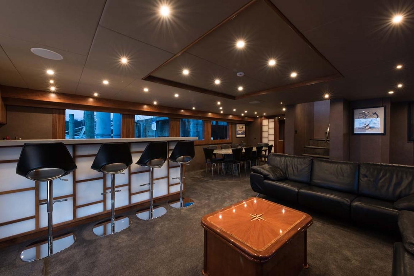 a living room with a couch and a table aboard PACIFIC HQ Yacht for Sale