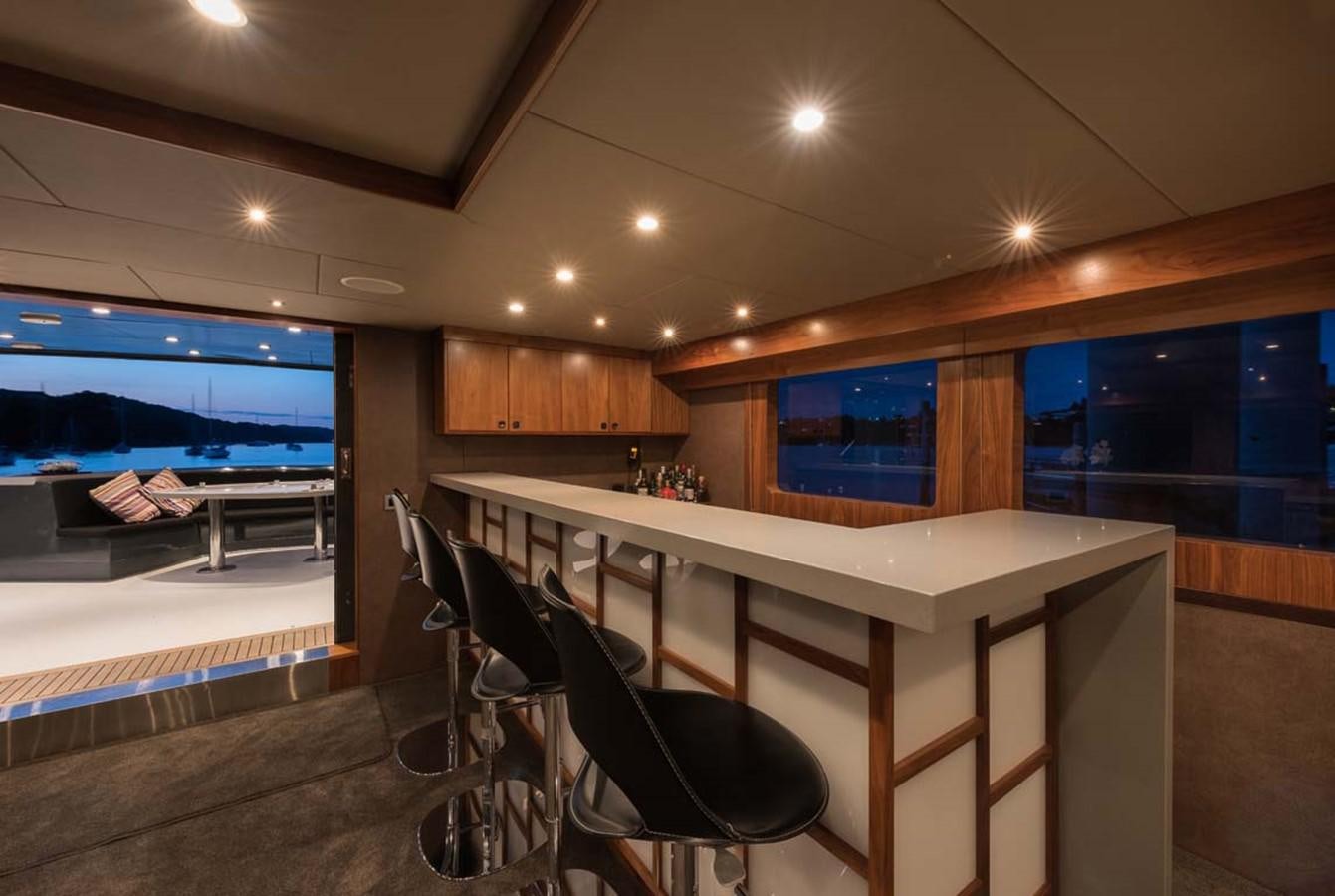 a room with a table and chairs aboard PACIFIC HQ Yacht for Sale