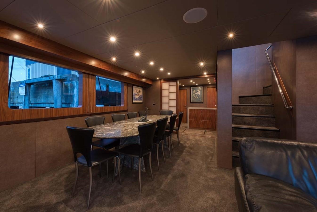 a large dining room with a staircase aboard PACIFIC HQ Yacht for Sale