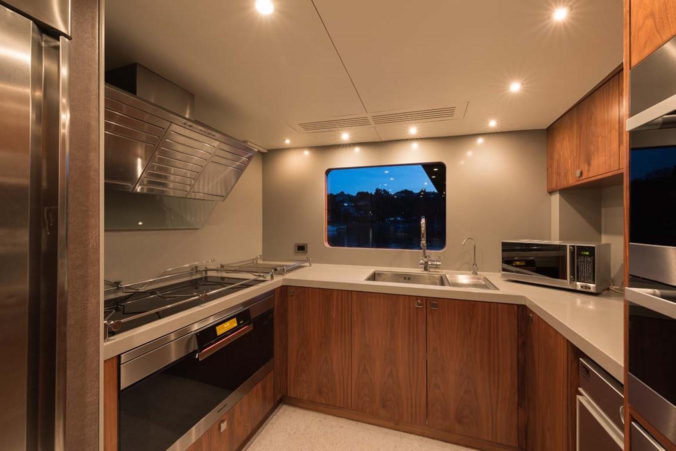 a kitchen with a tv on the wall aboard PACIFIC HQ Yacht for Sale