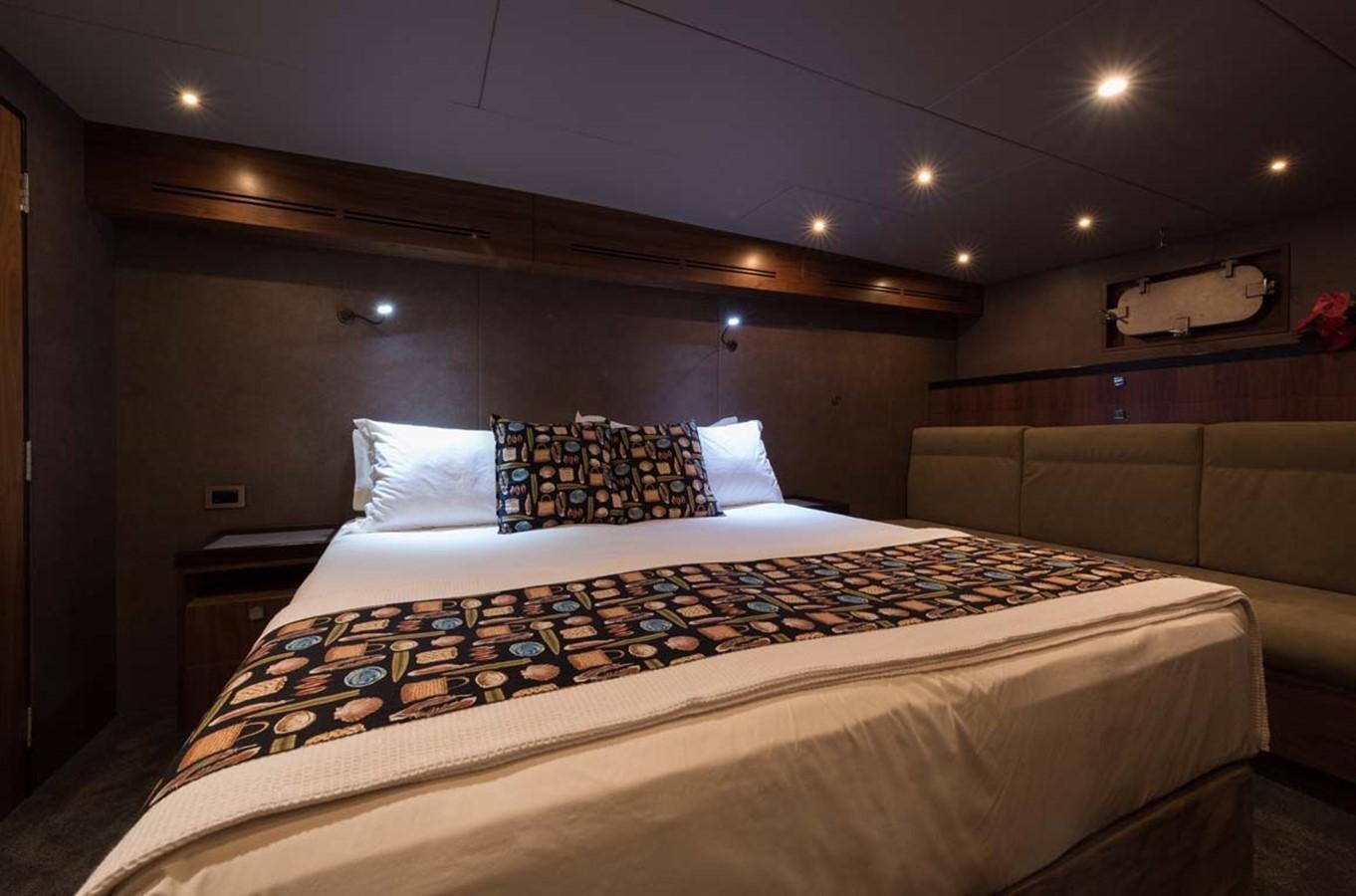 a bed with a couch and pillows aboard PACIFIC HQ Yacht for Sale