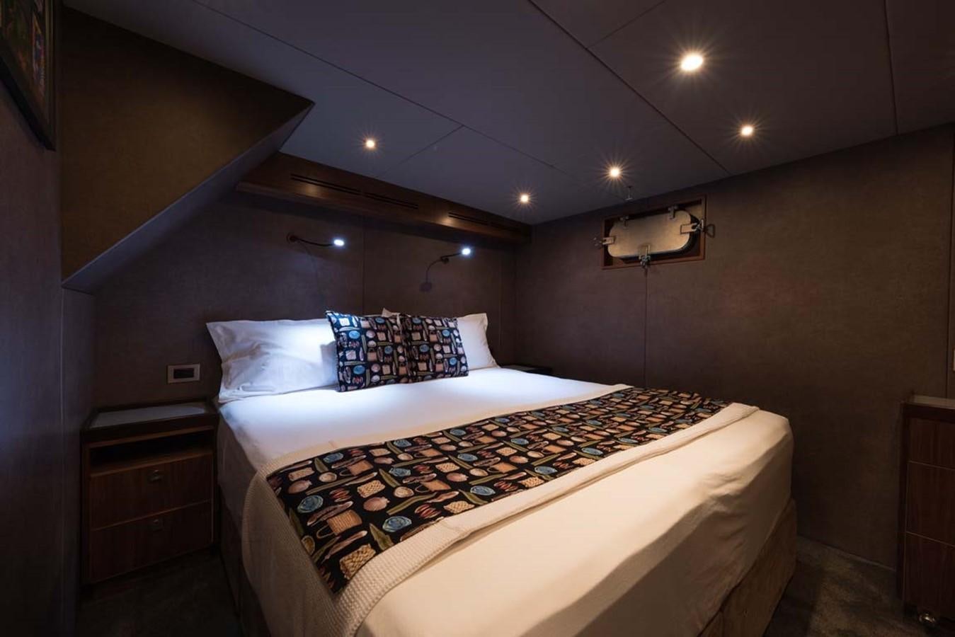 a bed with a black and white checkered blanket aboard PACIFIC HQ Yacht for Sale
