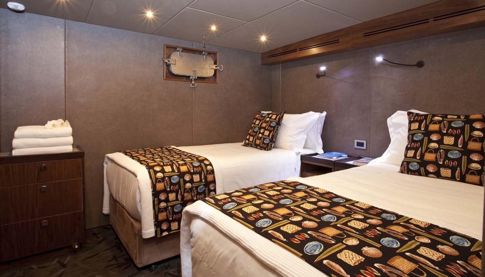 a couple of beds in a hotel room aboard PACIFIC HQ Yacht for Sale