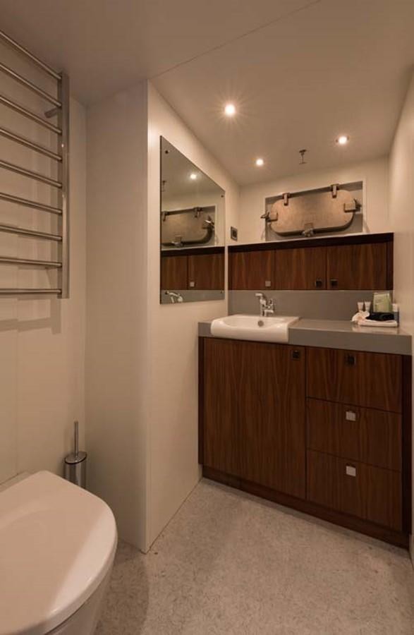 a bathroom with a sink and a mirror aboard PACIFIC HQ Yacht for Sale