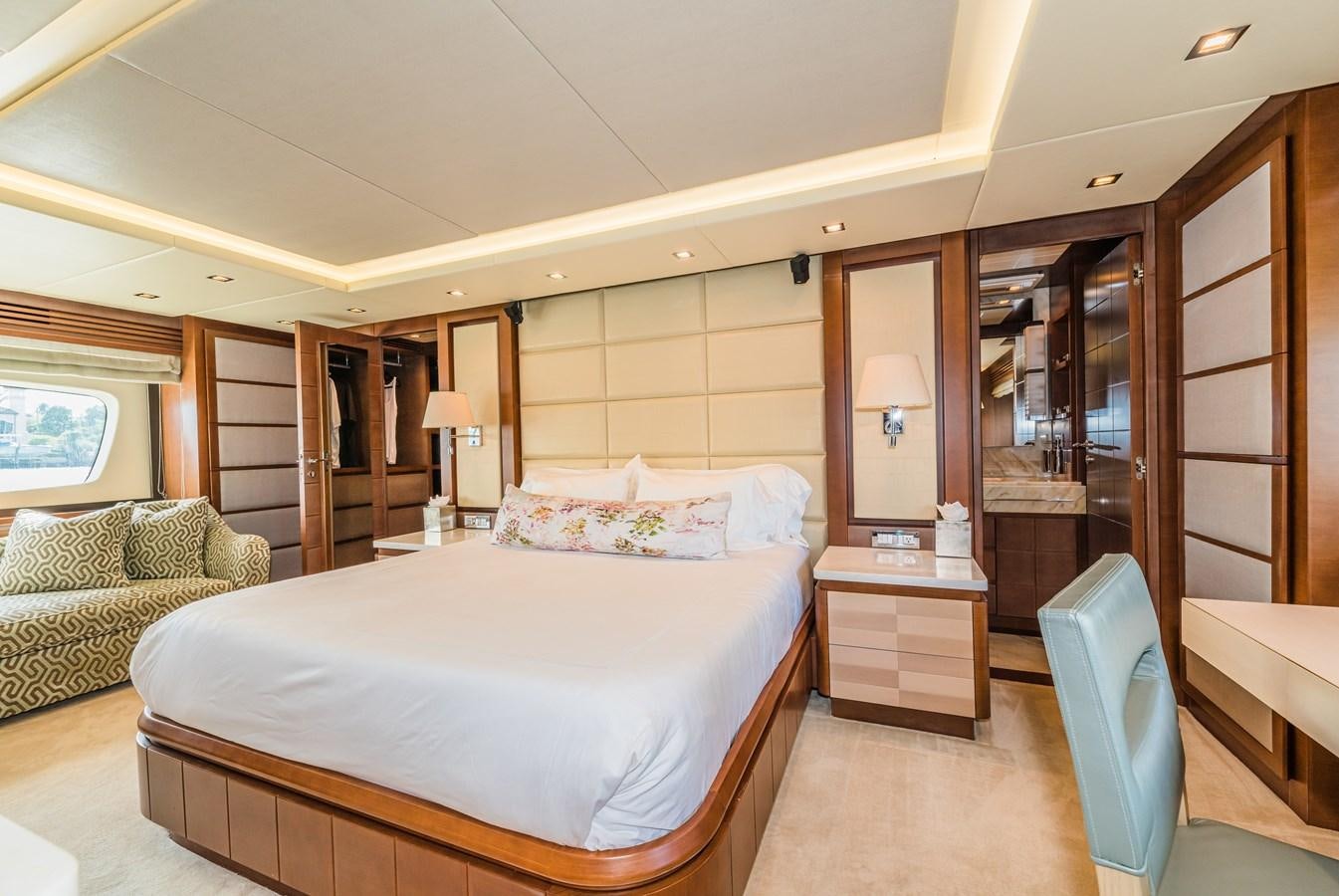 a bedroom with a bed and a couch aboard SEA HACK Yacht for Sale