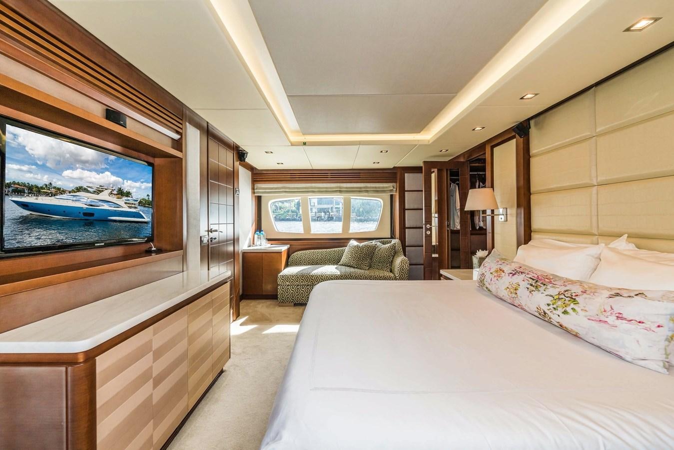 a bedroom with a large bed and a flat screen tv aboard SEA HACK Yacht for Sale