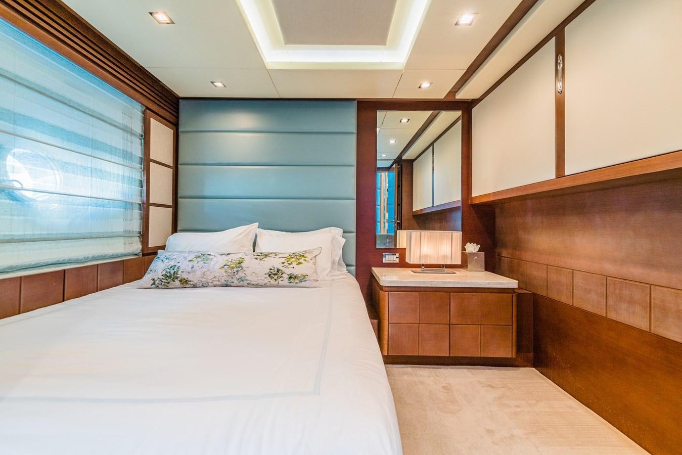 a bedroom with a bed and a dresser aboard SEA HACK Yacht for Sale