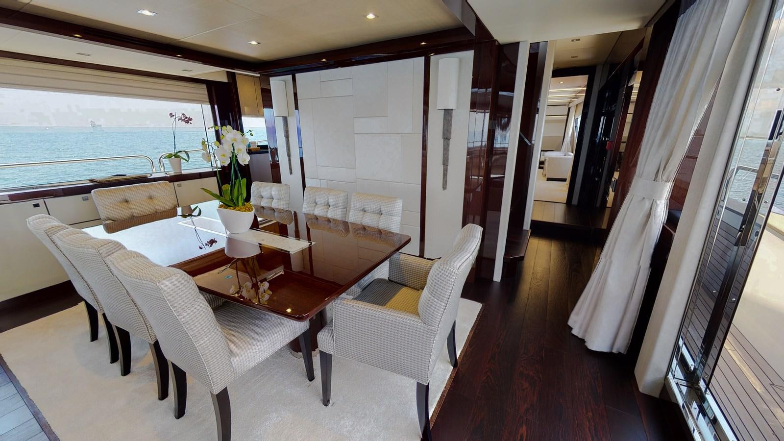 a room with a table chairs and a window aboard PV 95 Yacht for Sale