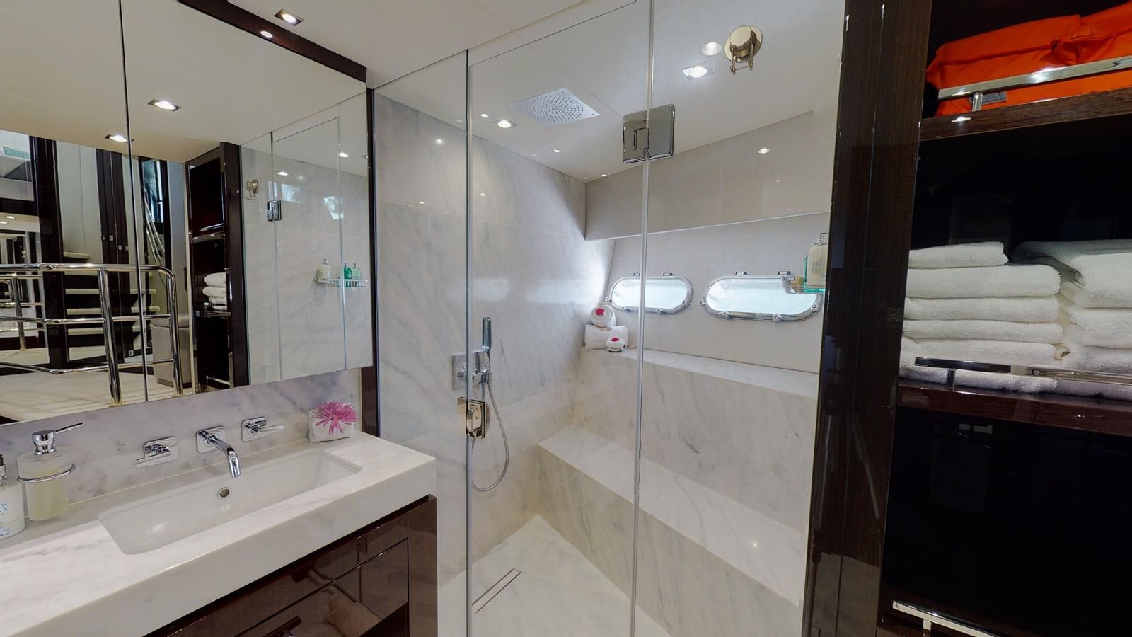 a bathroom with a glass shower aboard PV 95 Yacht for Sale