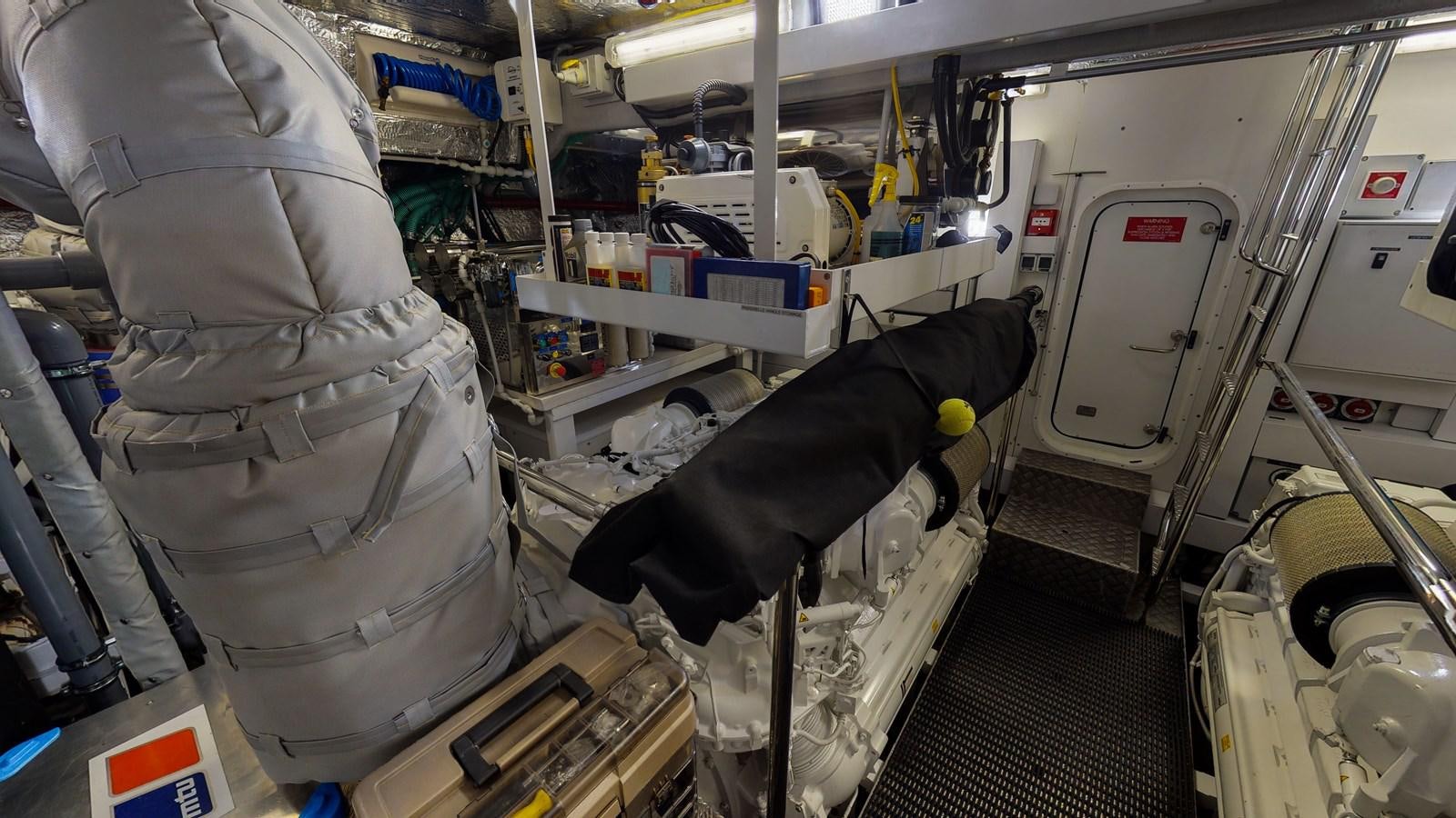 a person in a large grey helmet in a room with machines aboard PV 95 Yacht for Sale