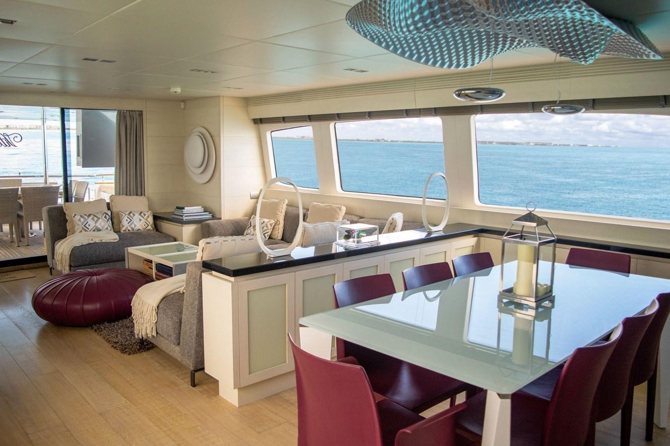 a room with a table chairs and a couch aboard VITA XL Yacht for Sale