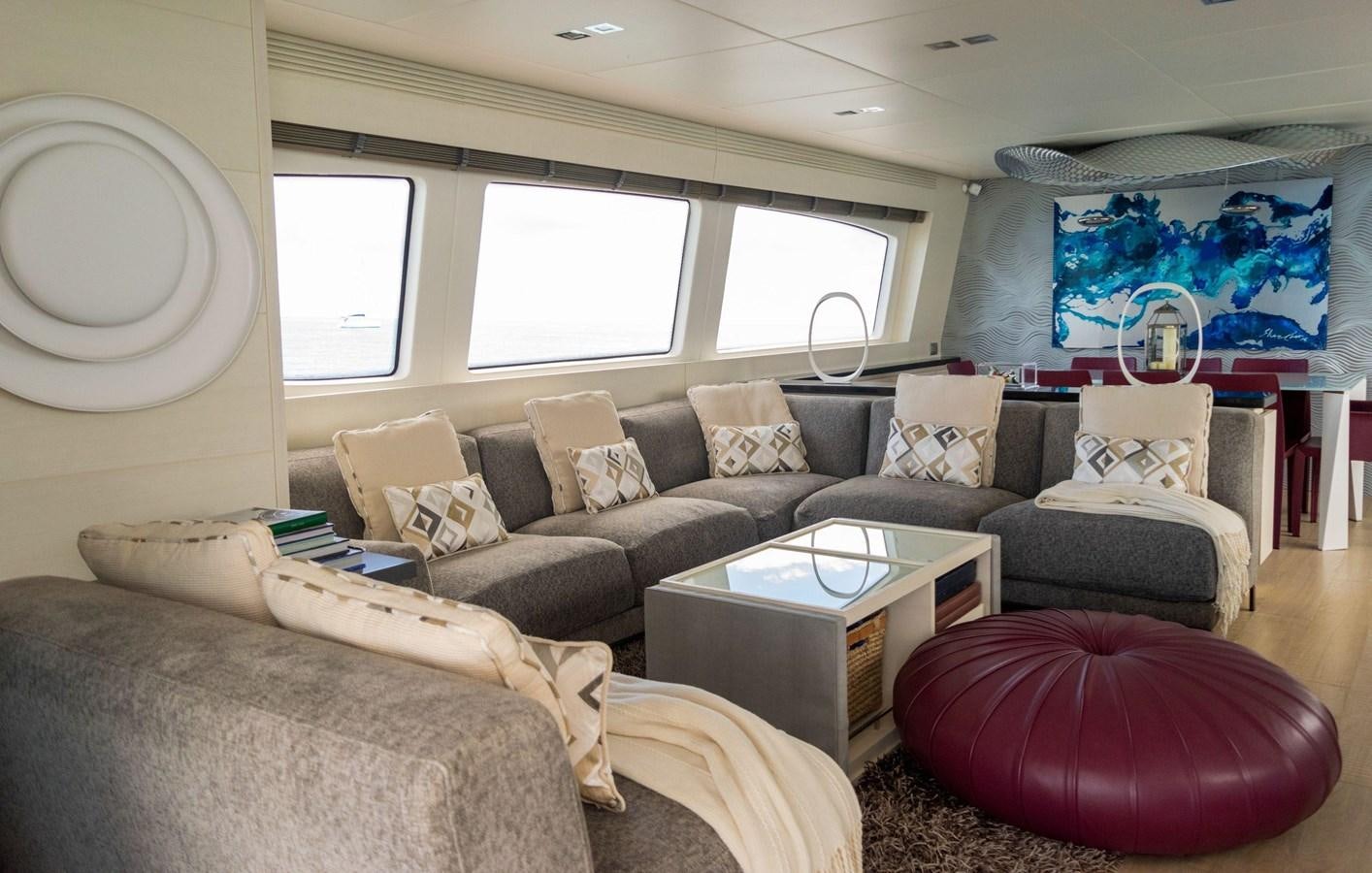 a living room with a couch and a television aboard VITA XL Yacht for Sale