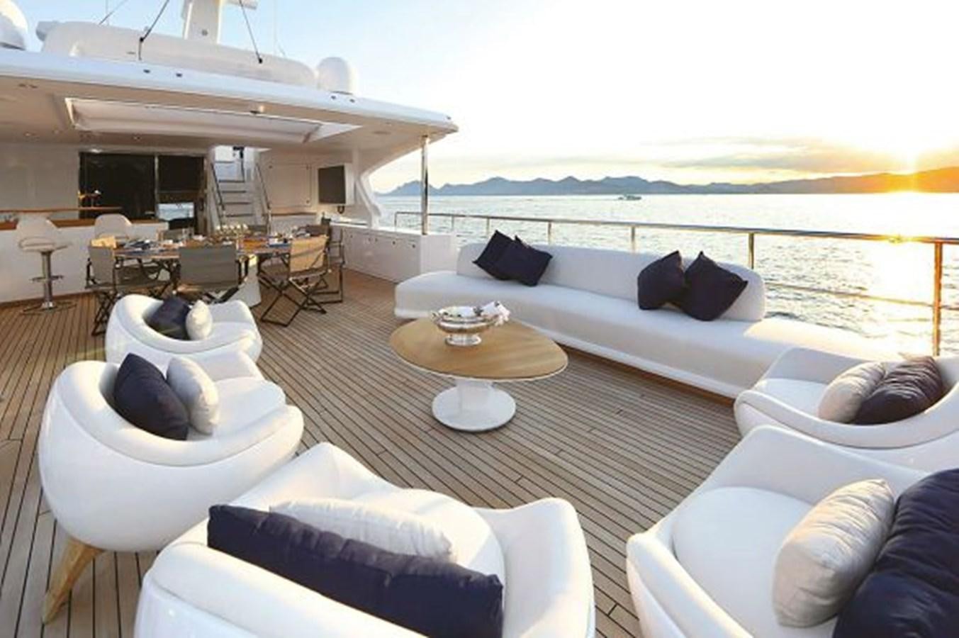 a living room with a large white couch and a large window aboard 2020 BENETTI DELFINO 95 Yacht for Sale