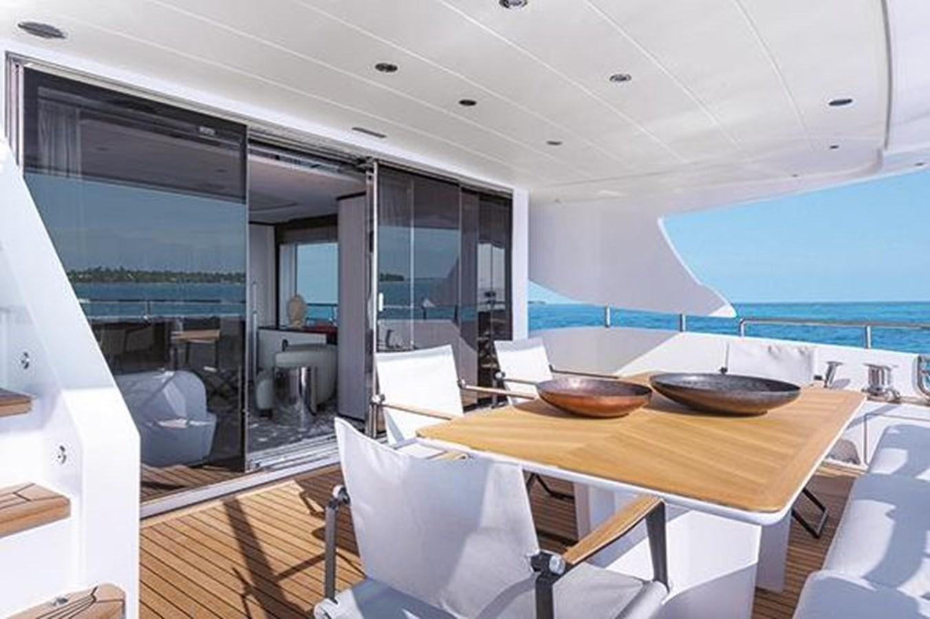 a room with a table and chairs aboard 2020 BENETTI DELFINO 95 Yacht for Sale