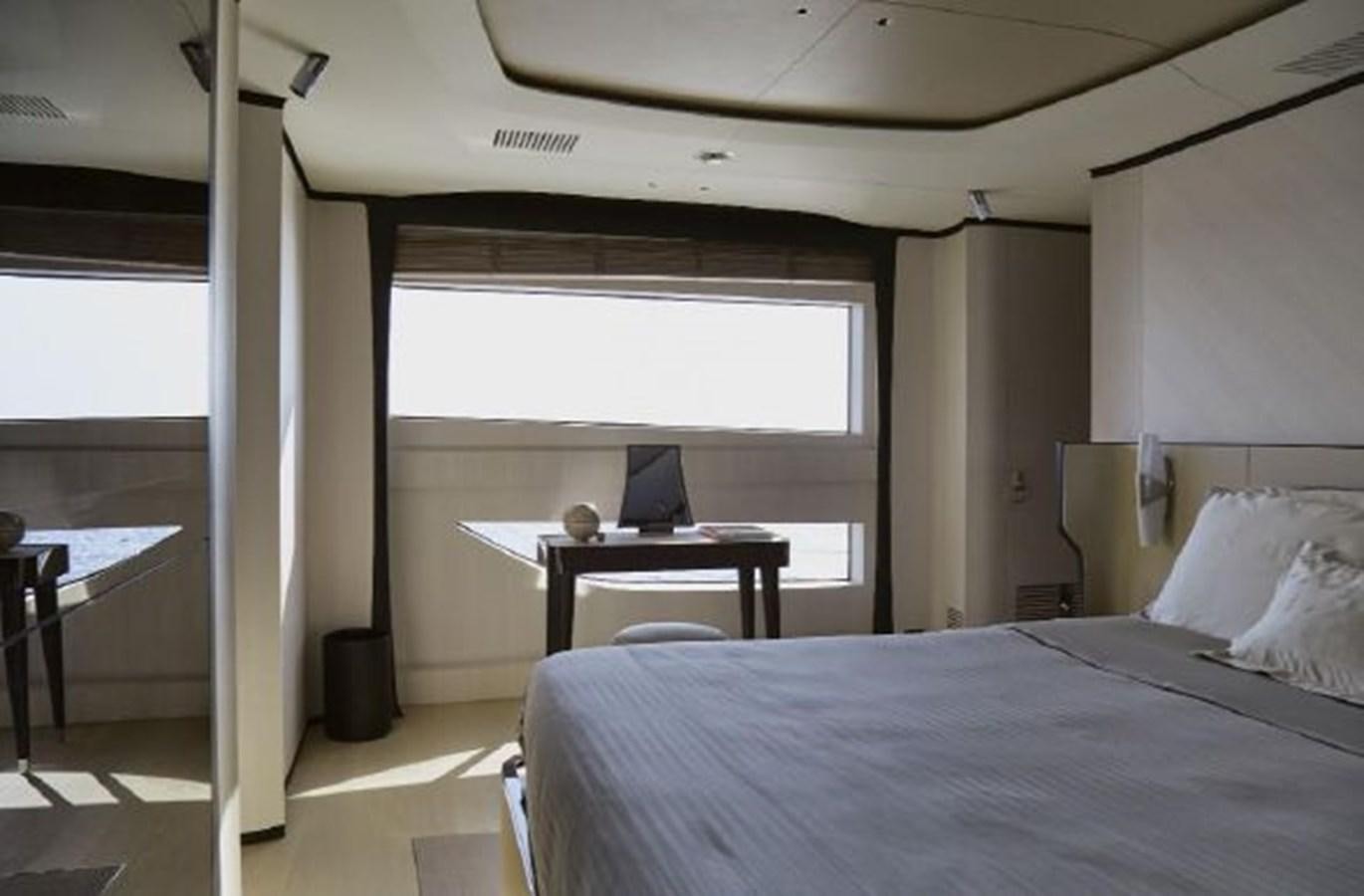 a room with a bed and a desk aboard 2020 BENETTI DELFINO 95 Yacht for Sale