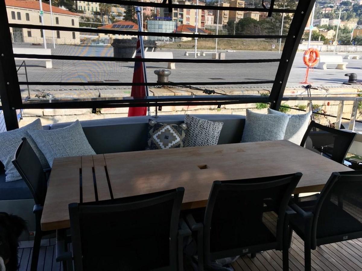 a table with chairs on it aboard KEROS ISLAND Yacht for Sale