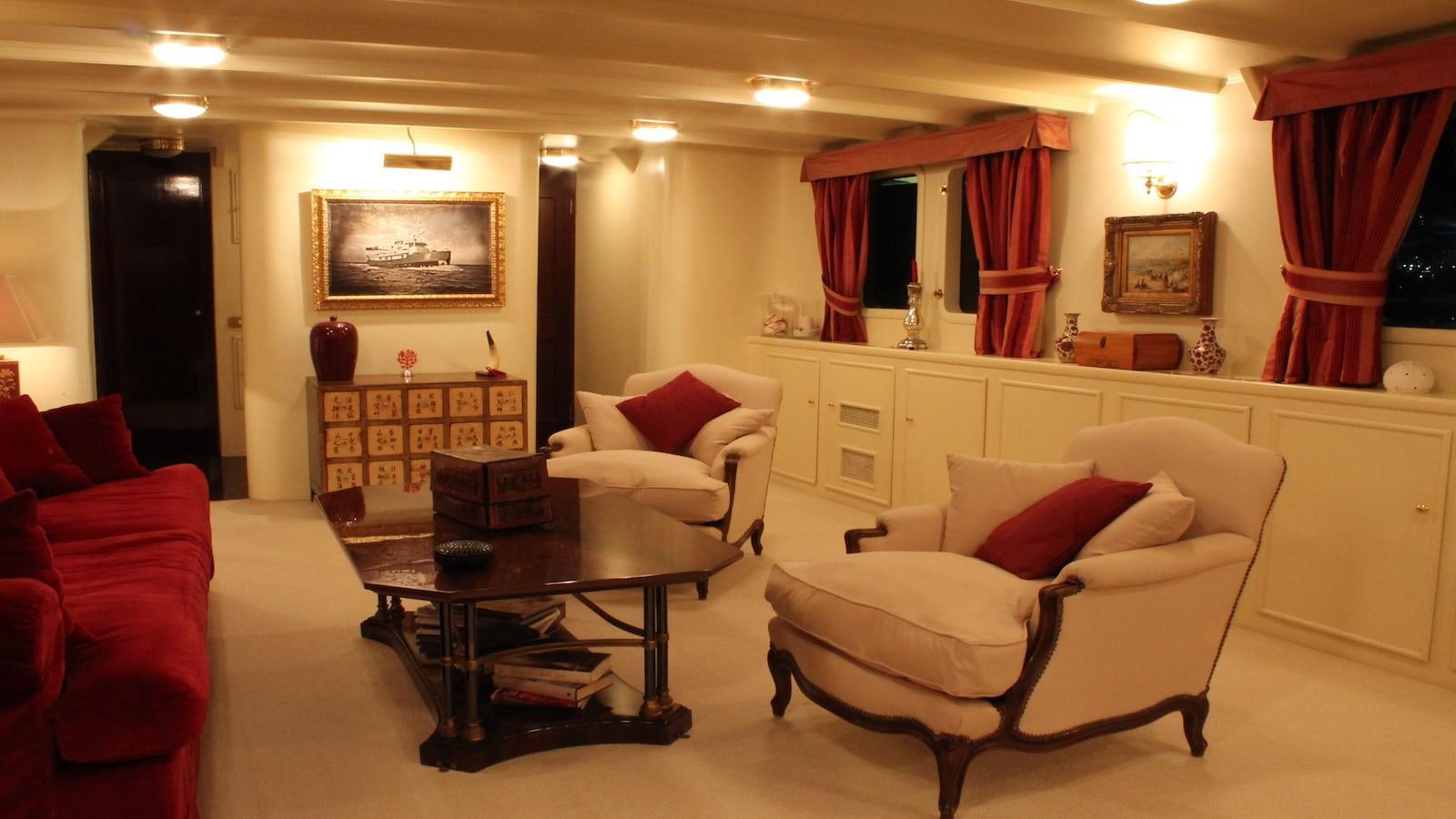 a living room with white furniture aboard DP MONITOR Yacht for Sale
