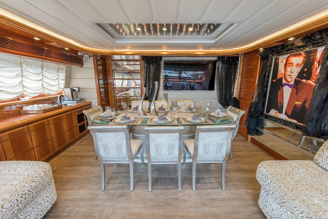 a large room with a table and chairs aboard 00Z Yacht for Sale