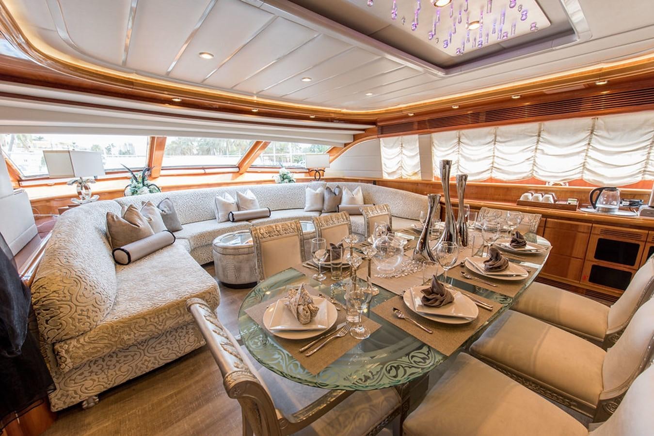 a large living room with a large table and chairs aboard 00Z Yacht for Sale