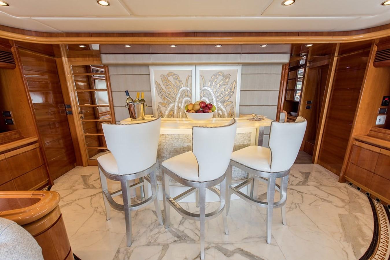 a room with chairs and a table aboard 00Z Yacht for Sale