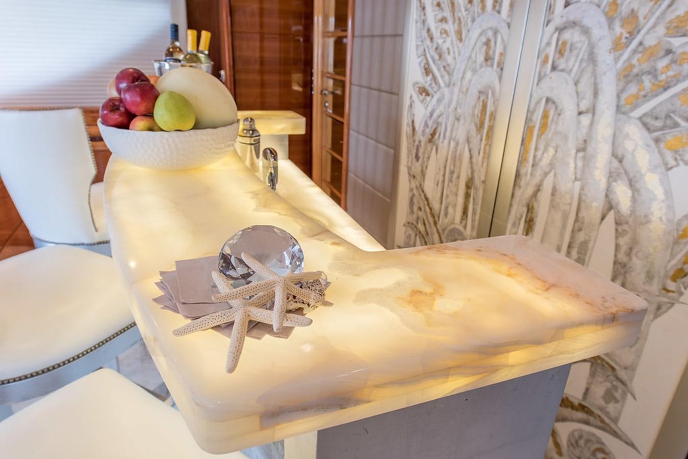 a bed with a white sheet and a white chair and a white chair aboard 00Z Yacht for Sale