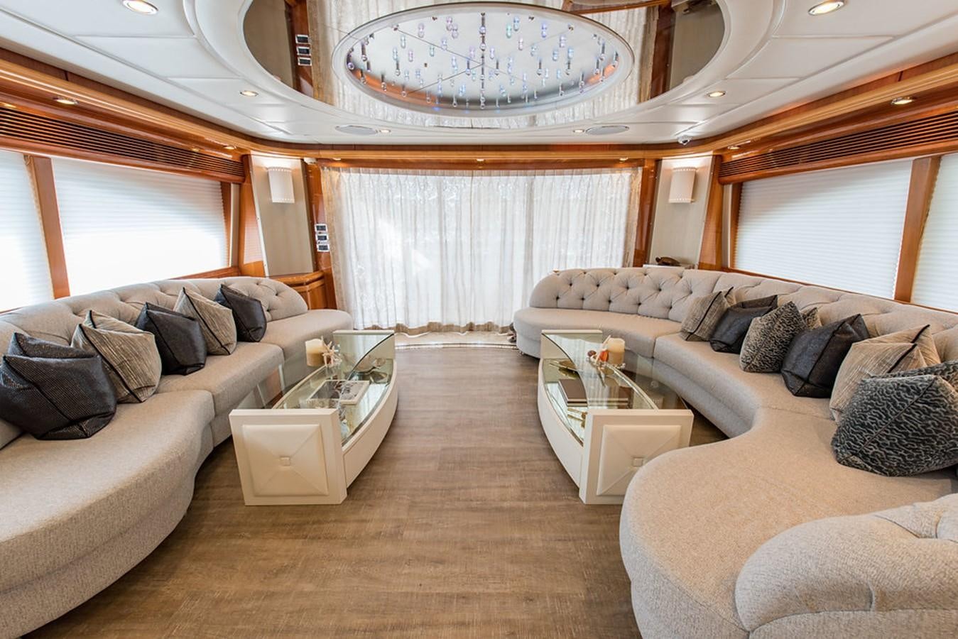 a large living room with a large chandelier aboard 00Z Yacht for Sale