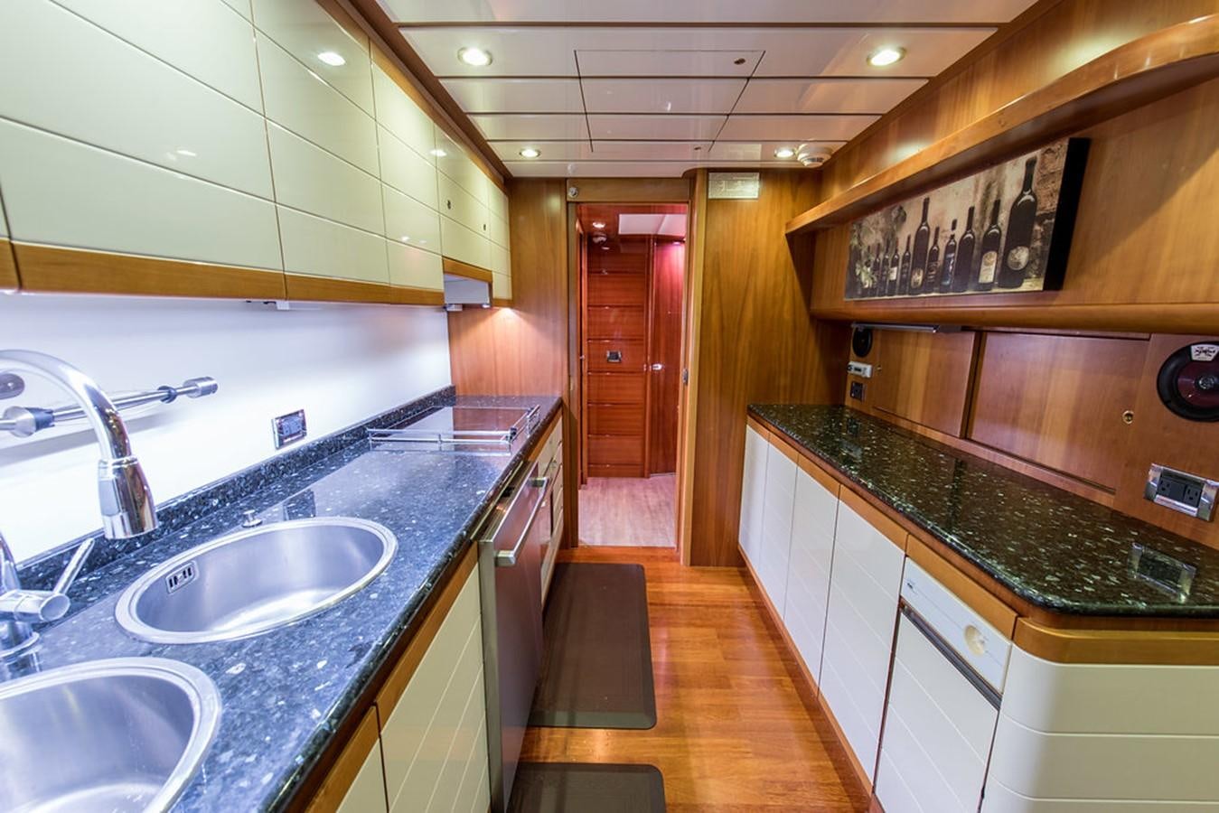a kitchen with a countertop sink and cabinets aboard 00Z Yacht for Sale