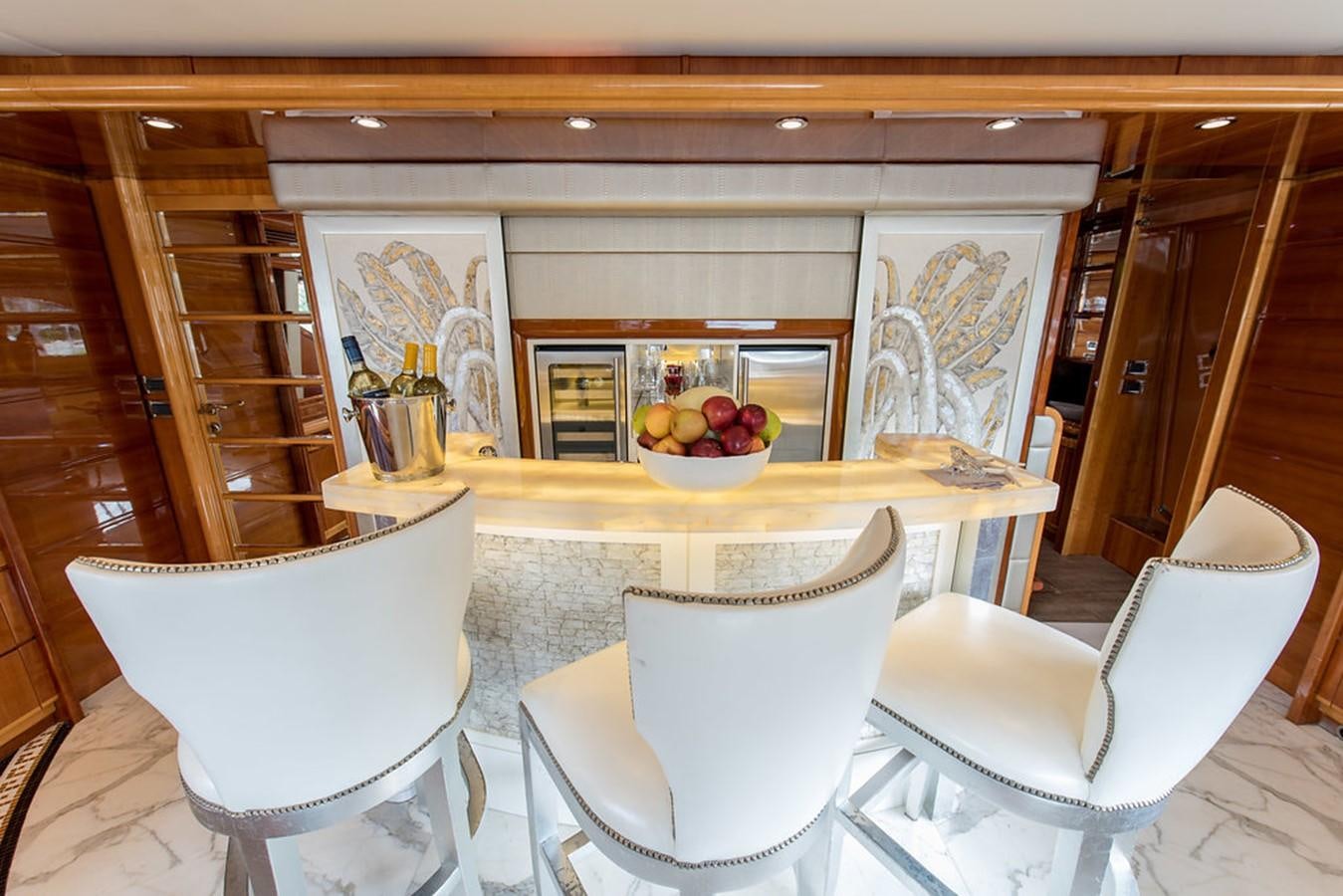 a table with chairs and a vase of apples on it aboard 00Z Yacht for Sale
