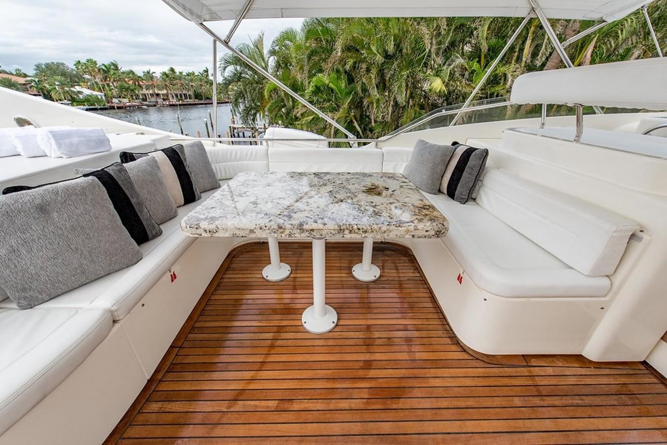 a group of white couches on a deck aboard 00Z Yacht for Sale