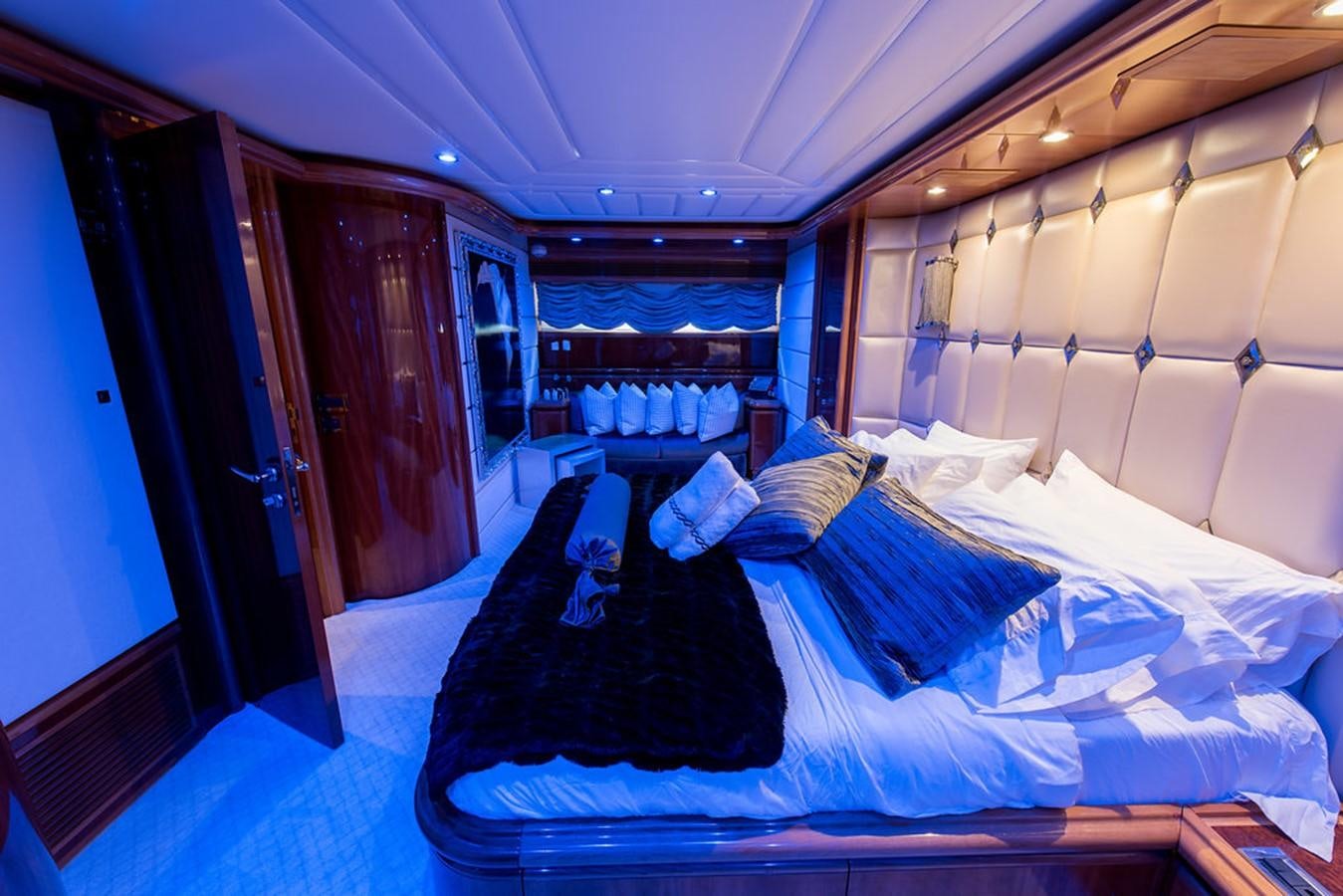 a room with a bed and a blue door aboard 00Z Yacht for Sale