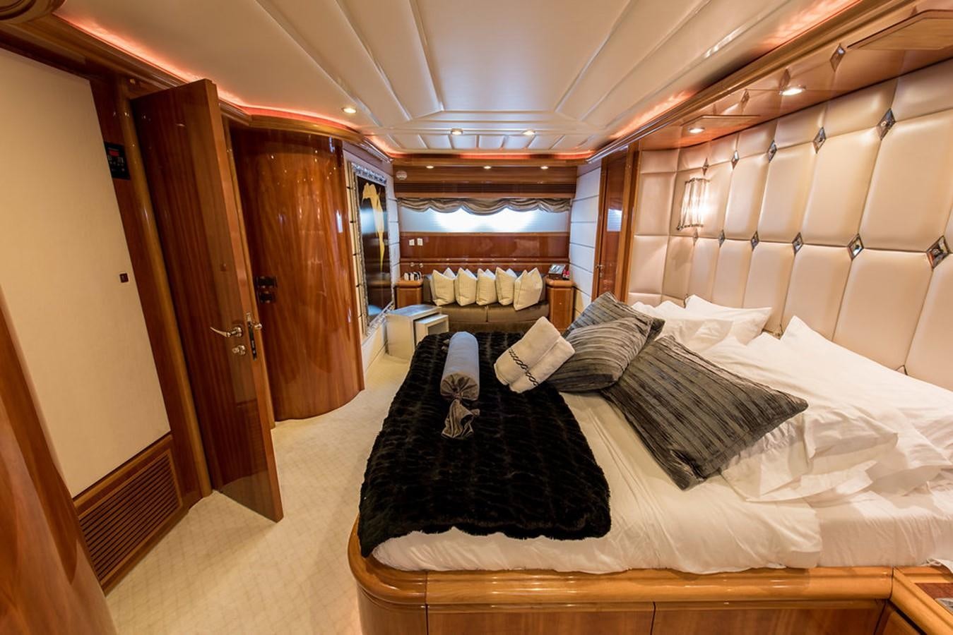 a room with a bed and a wood door aboard 00Z Yacht for Sale