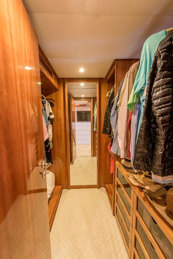 a closet with clothes on the wall aboard 00Z Yacht for Sale