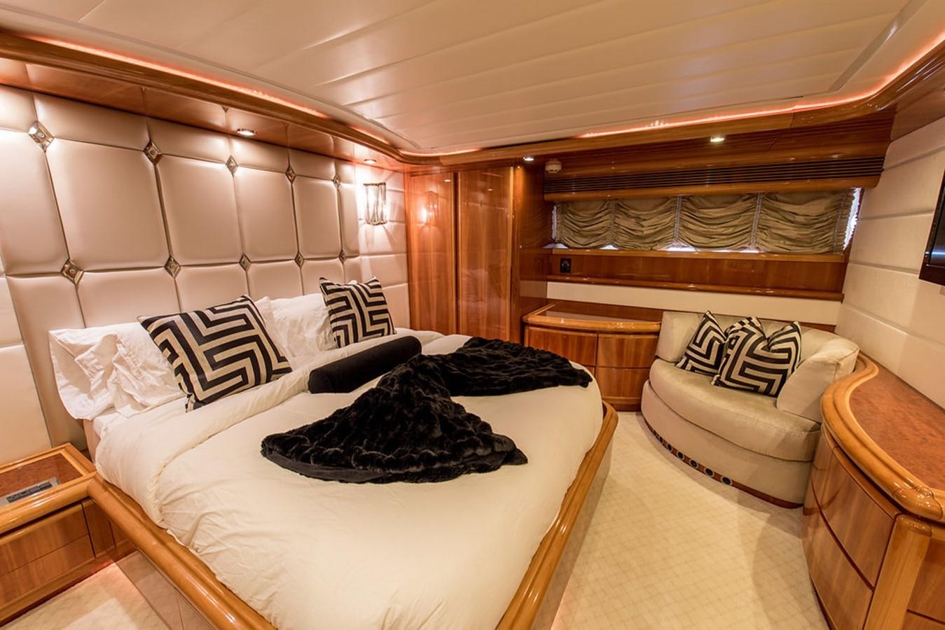 a room with a bed and a couch aboard 00Z Yacht for Sale