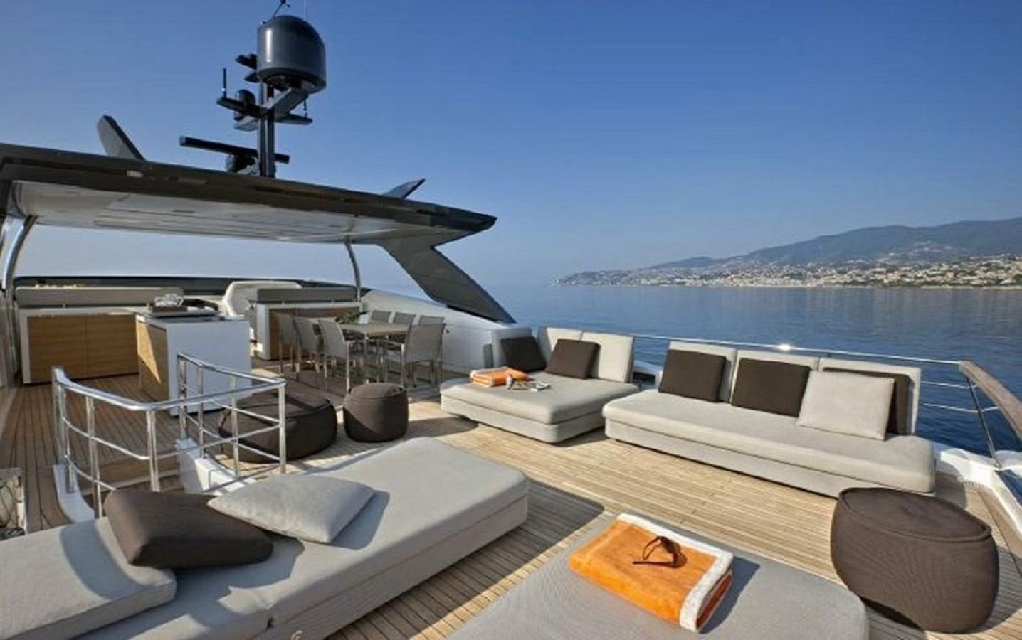 a deck with a view of the ocean and a large boat aboard AGAIN Yacht for Sale