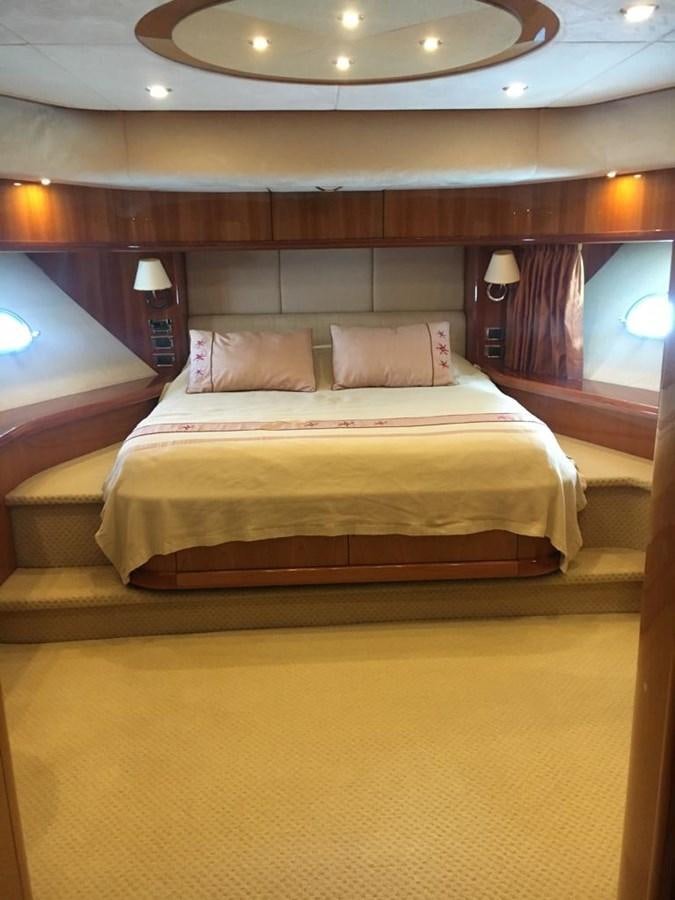 a bed with a white cover aboard FUNTASEA Yacht for Sale