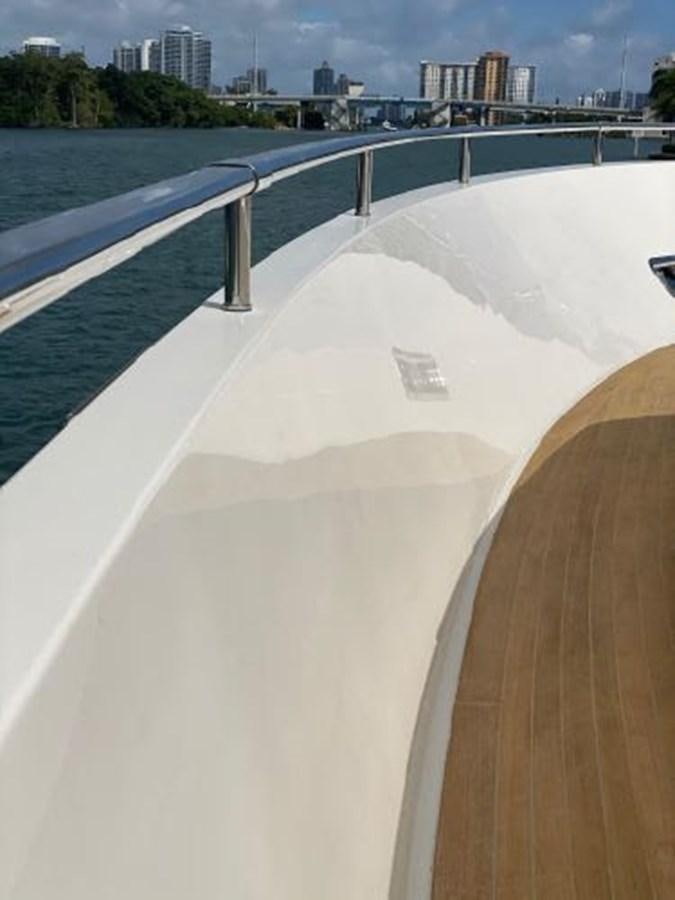 a large white pool with a city in the background aboard ASTONISH Yacht for Sale