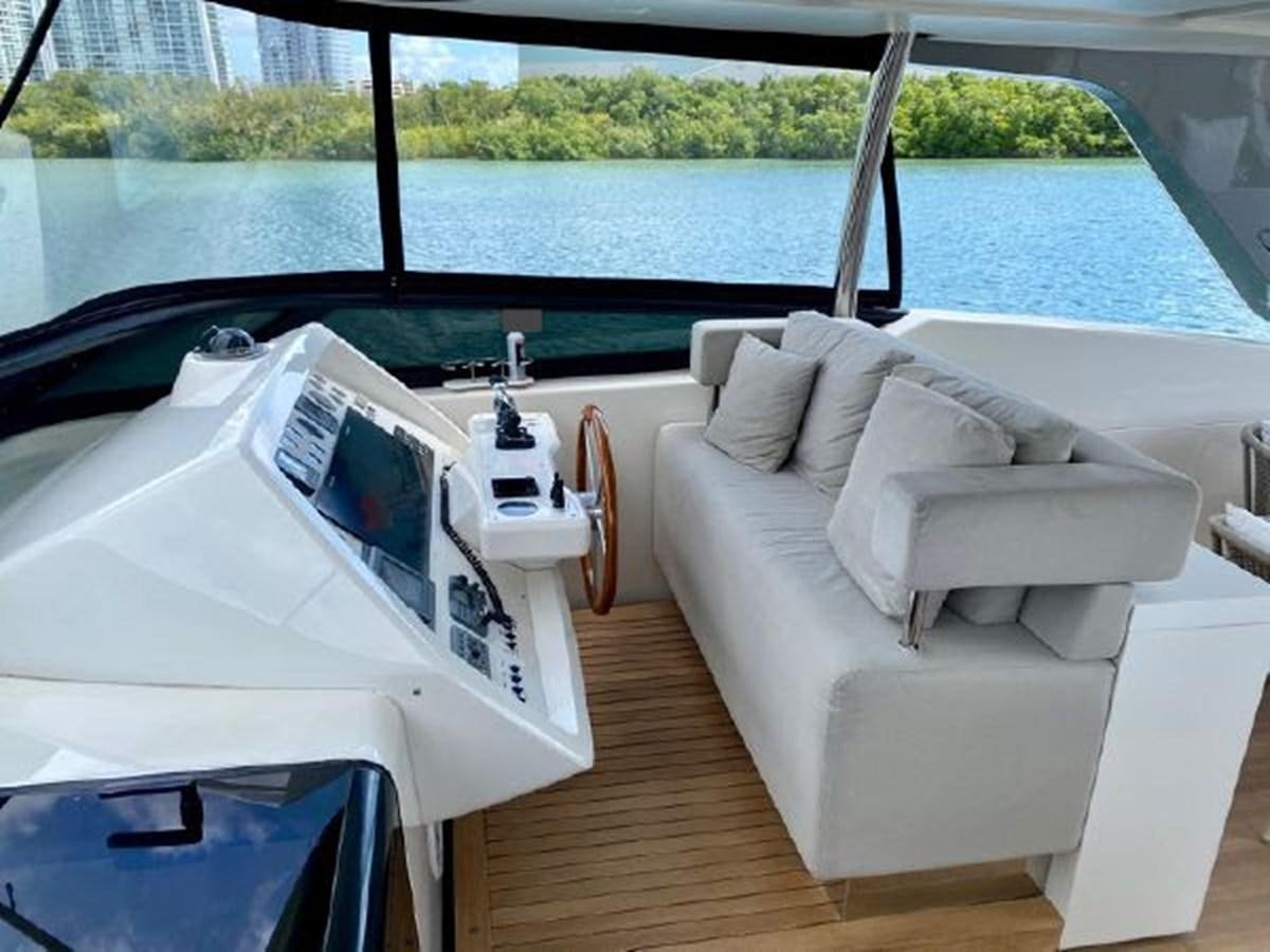 a room with a bed and a large window aboard ASTONISH Yacht for Sale