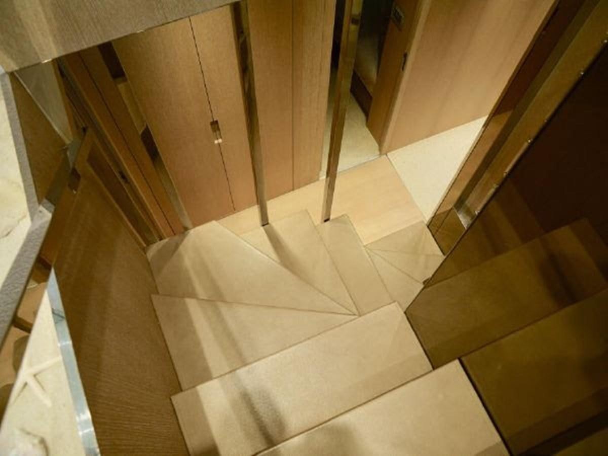 a staircase with white carpet aboard ASTONISH Yacht for Sale