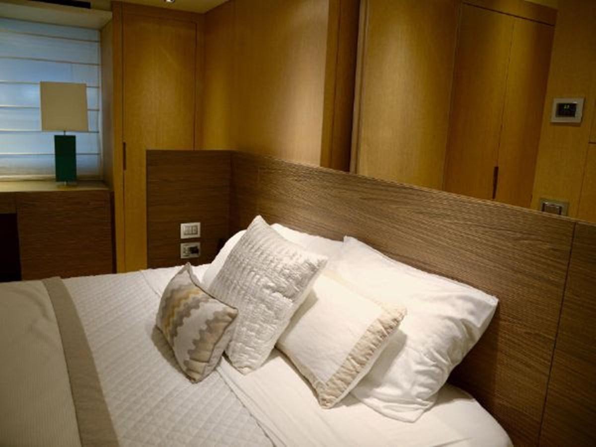 a bed with pillows aboard ASTONISH Yacht for Sale