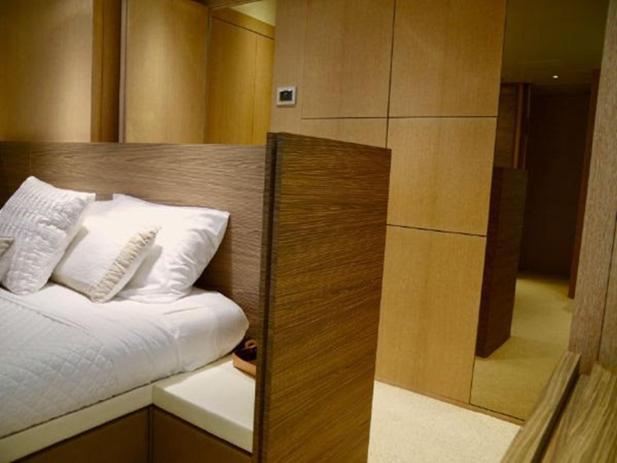 a bed with white sheets aboard ASTONISH Yacht for Sale