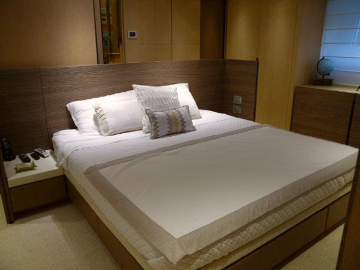 a bed with white sheets aboard ASTONISH Yacht for Sale